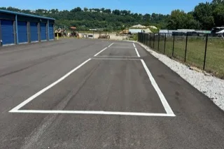 Marked outdoor parking space at the Dayton RV lot, alongside the drive-up storage building